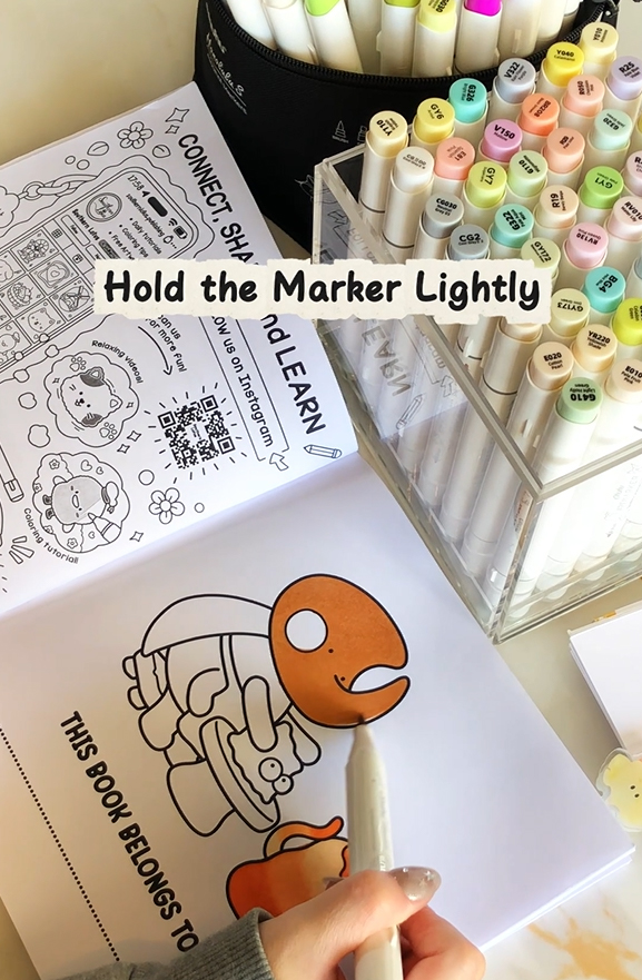 Holding markers lightly to reduce streaks and improve control